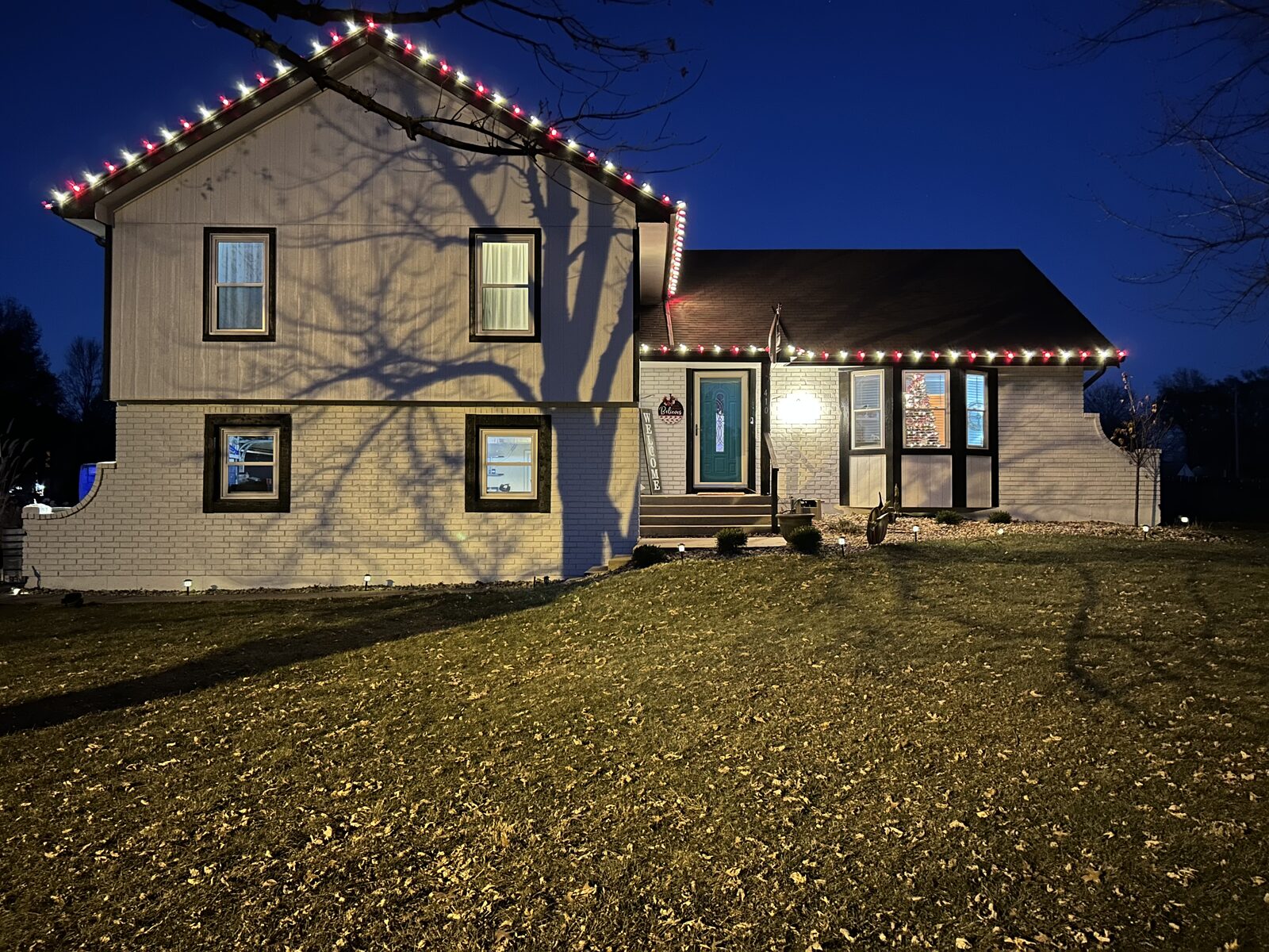 Residential Christmas light installation — warm white and color C9 LED bulbs